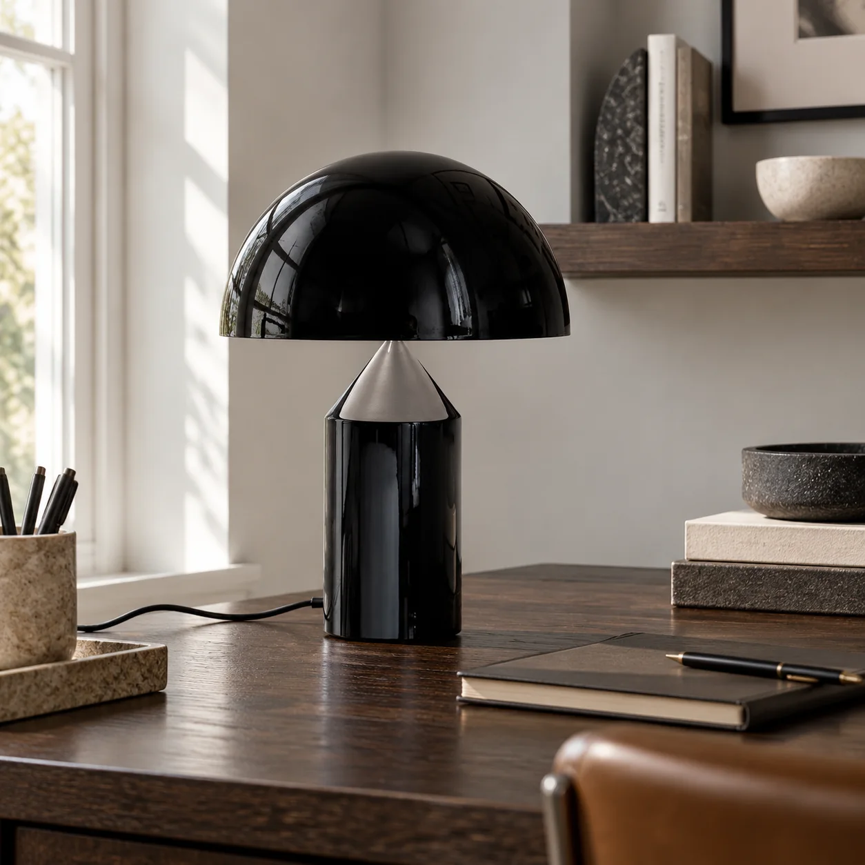 Glossy black HaloVell lamp on a home office desk