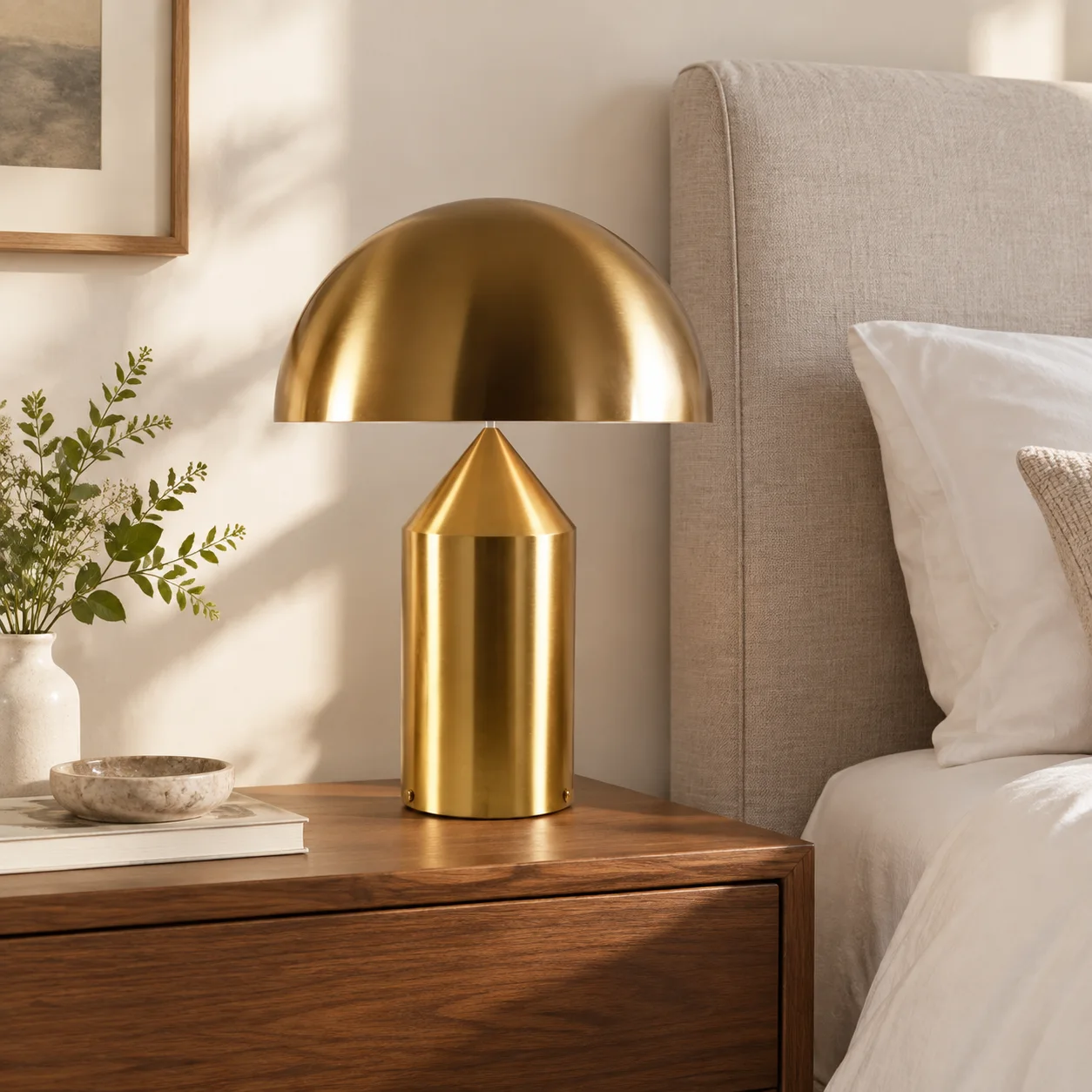 Gold HaloVell lamp on a walnut bedside table
