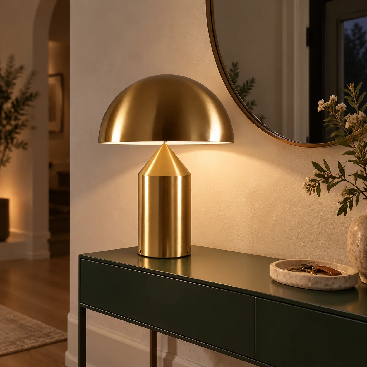 Gold HaloVell lamp on a dark green entry console