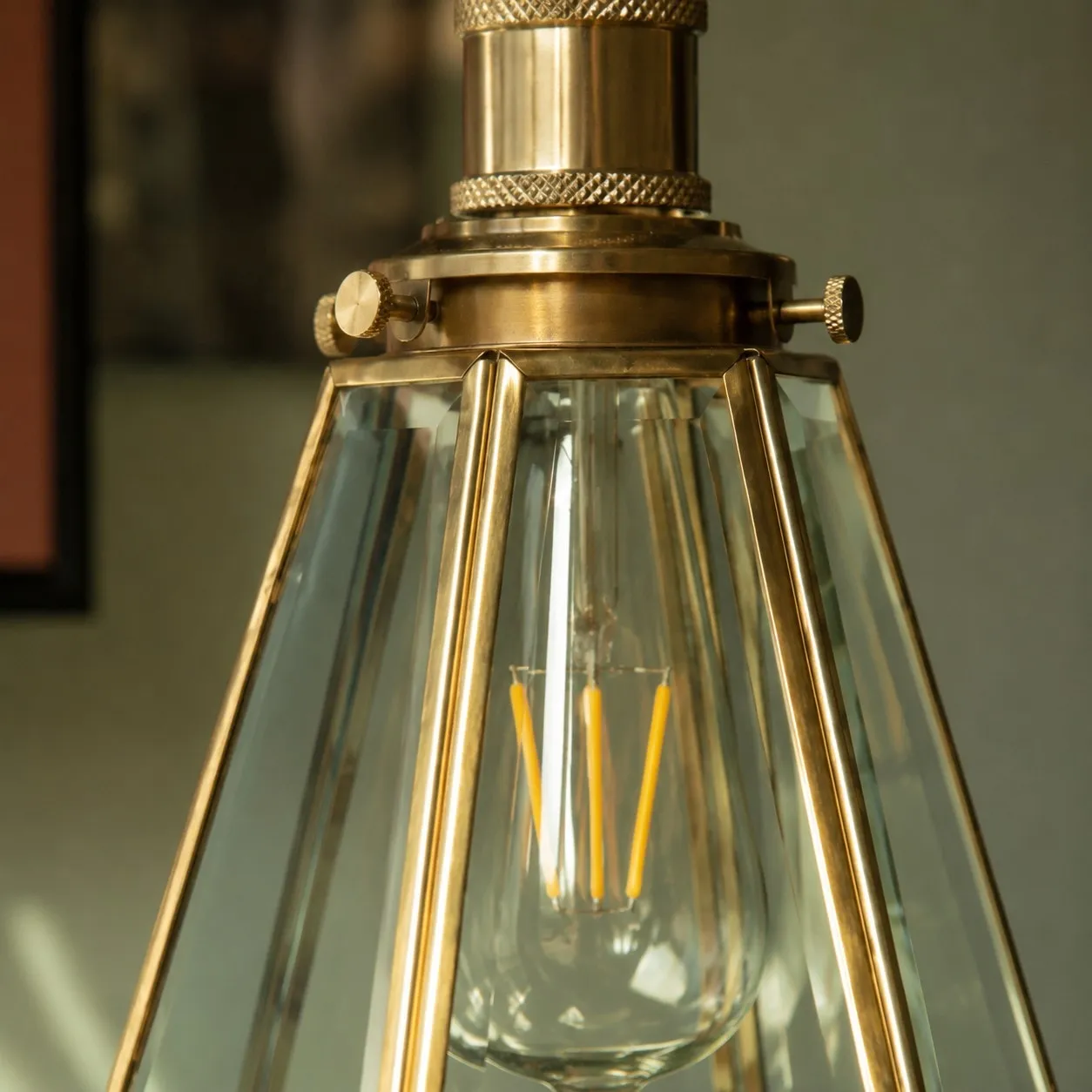 Close view of clear glass shade and brass frame