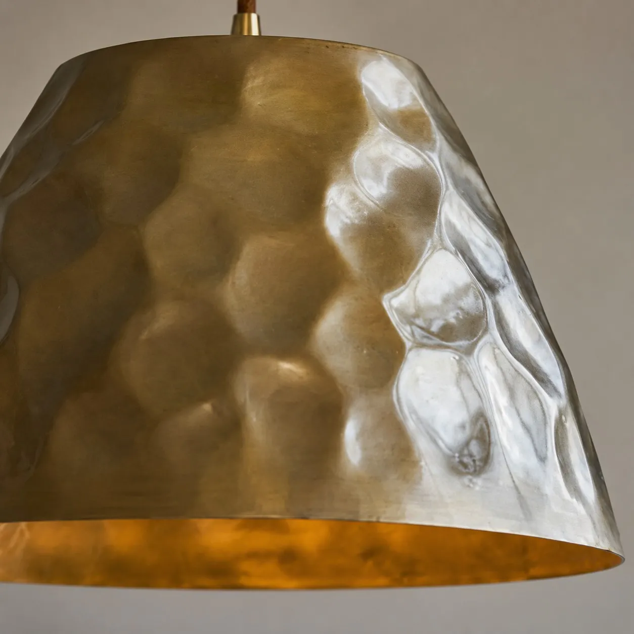 Close-up of hammered metal texture on the brass shade