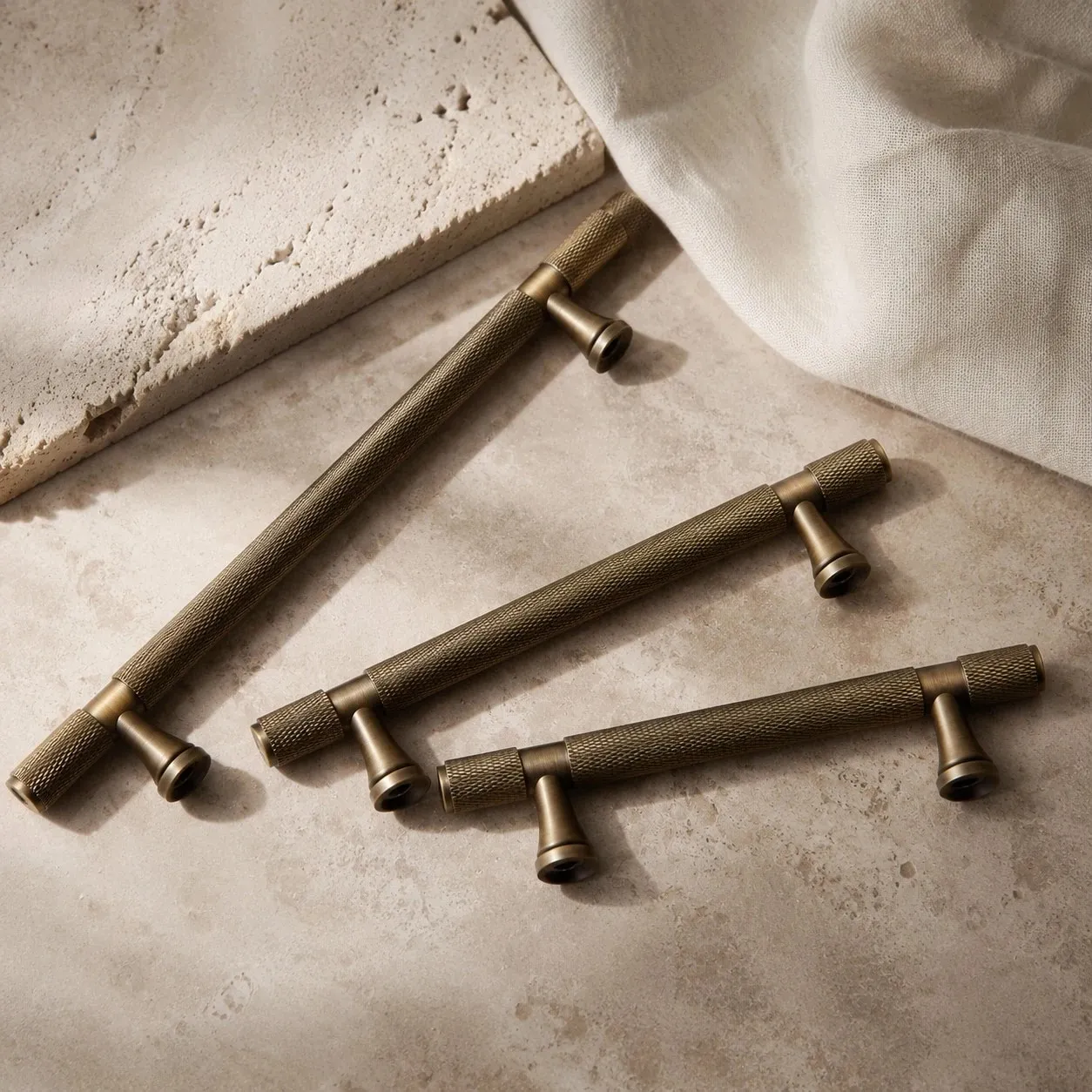Antique brass cabinet pulls grouped on stone surface