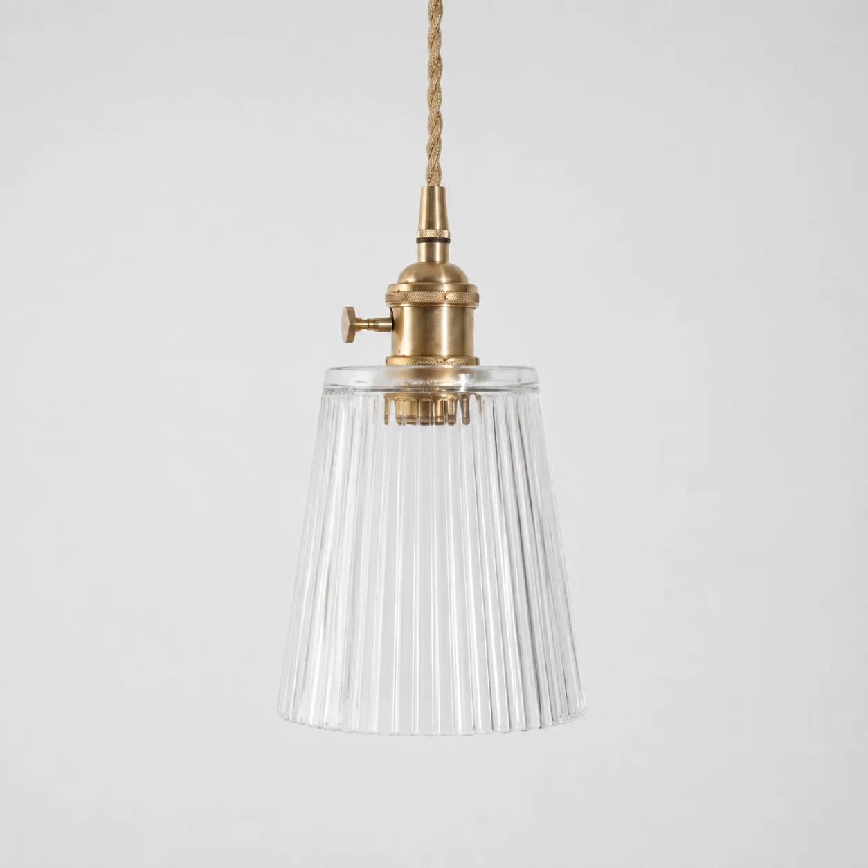 Style L - Clear textured glass shade with antique brass E27 socket, front view